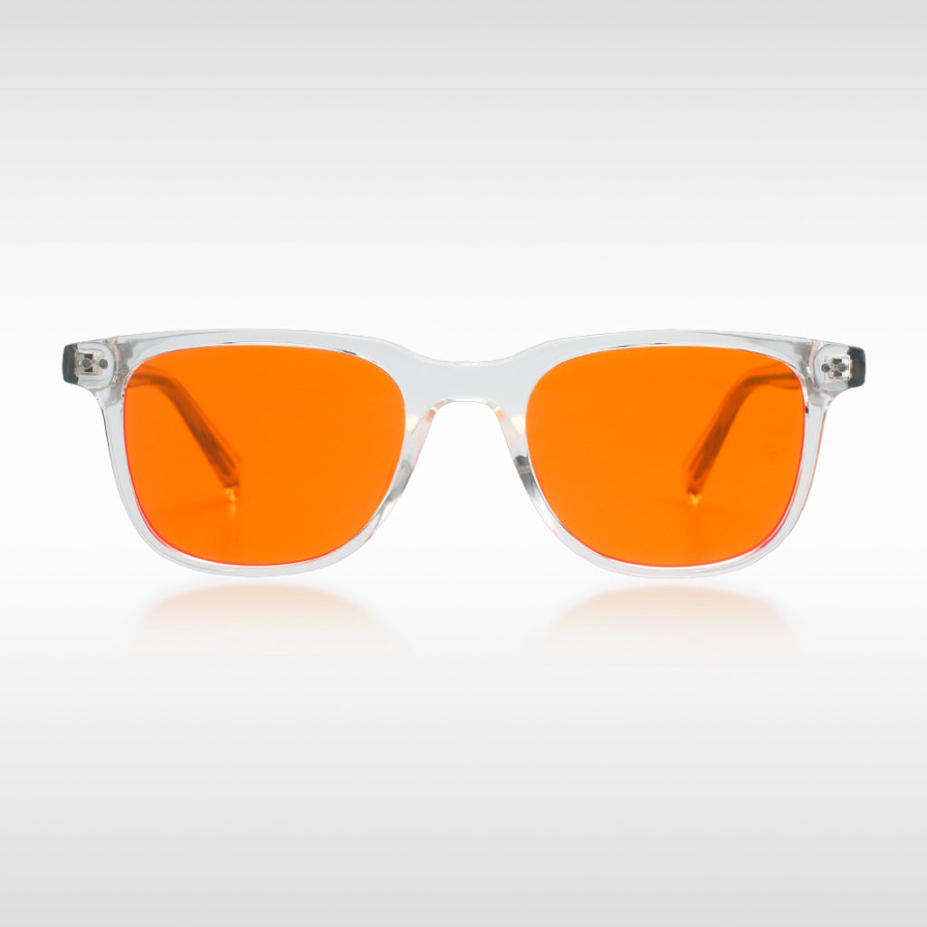 Blue light blockers with orange lenses and clear frame on a white background